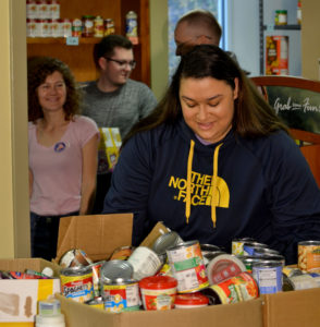 Volunteers stock shelves at the food pantry at Patrick Henry Community College.