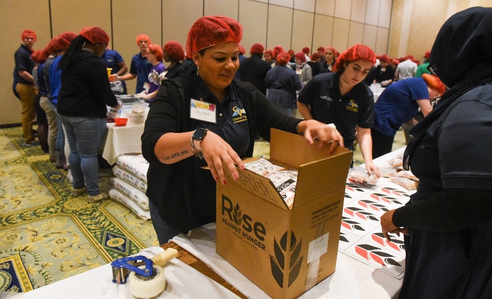 Students packing boxes with food