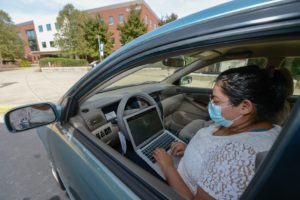 Image of female driver with laptop in her lap
