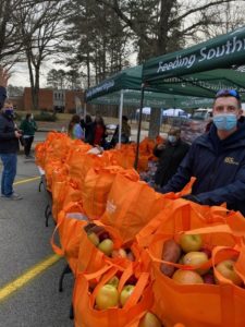 Image of dozens of food bags on display outside a local market