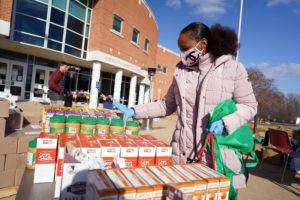 Image of young girl taking stock of food items