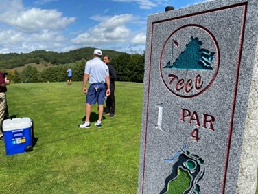 Two golfers prepare to tee-off on a par 4 hole