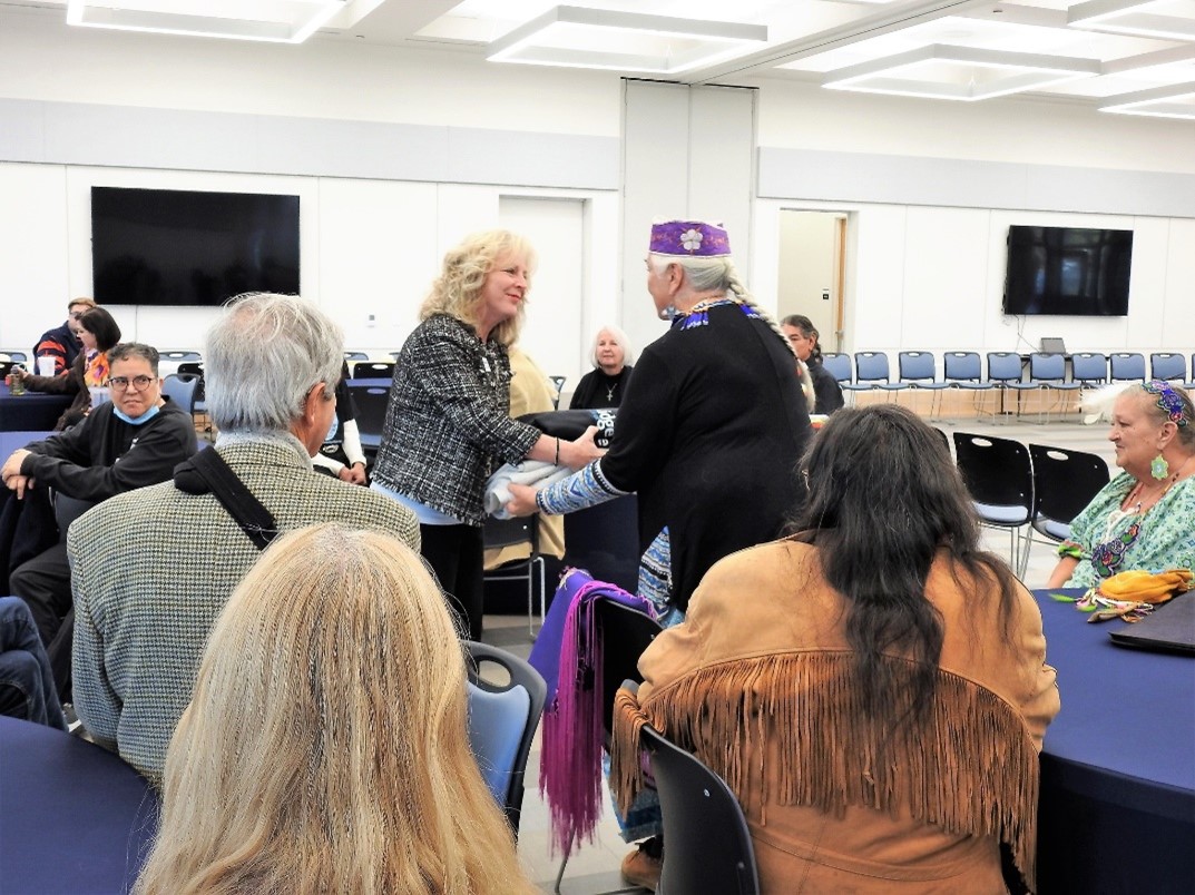LRCC President Kim Blosser shakes hands with native American