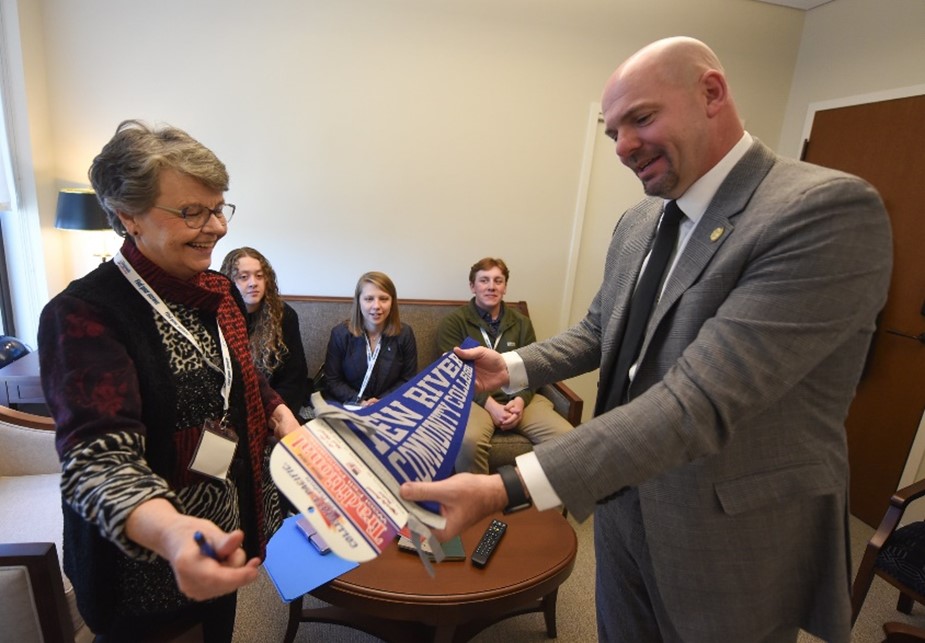 Image of NRCC President Pat Huber being presented with banner