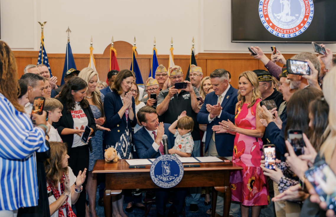 Image of governor at signing ceremony