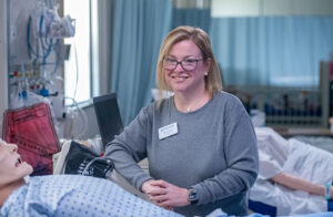 Woman in medical lab with dummies