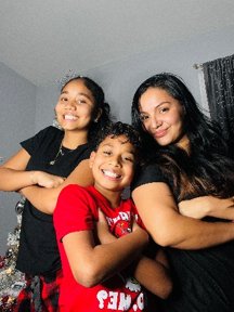 Maria Del Castaneda Juarez smiling with her two children